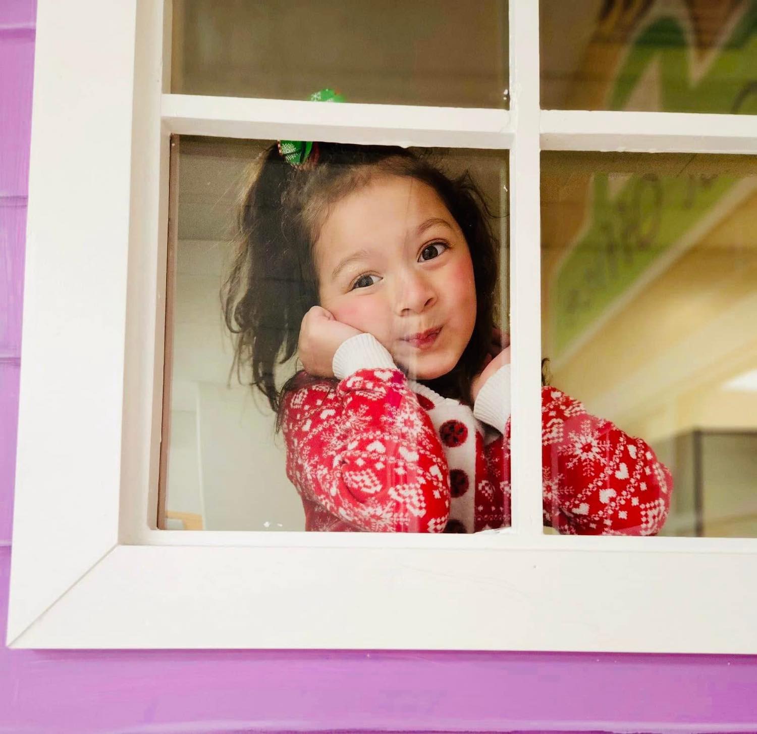 Child looking through window at Smart Beginnings