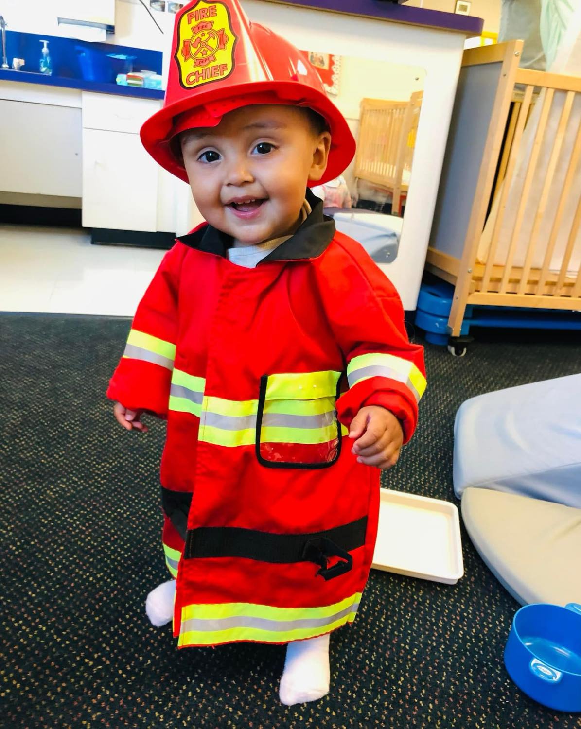 Baby in firefighter costume at Smart Beginnings Academy