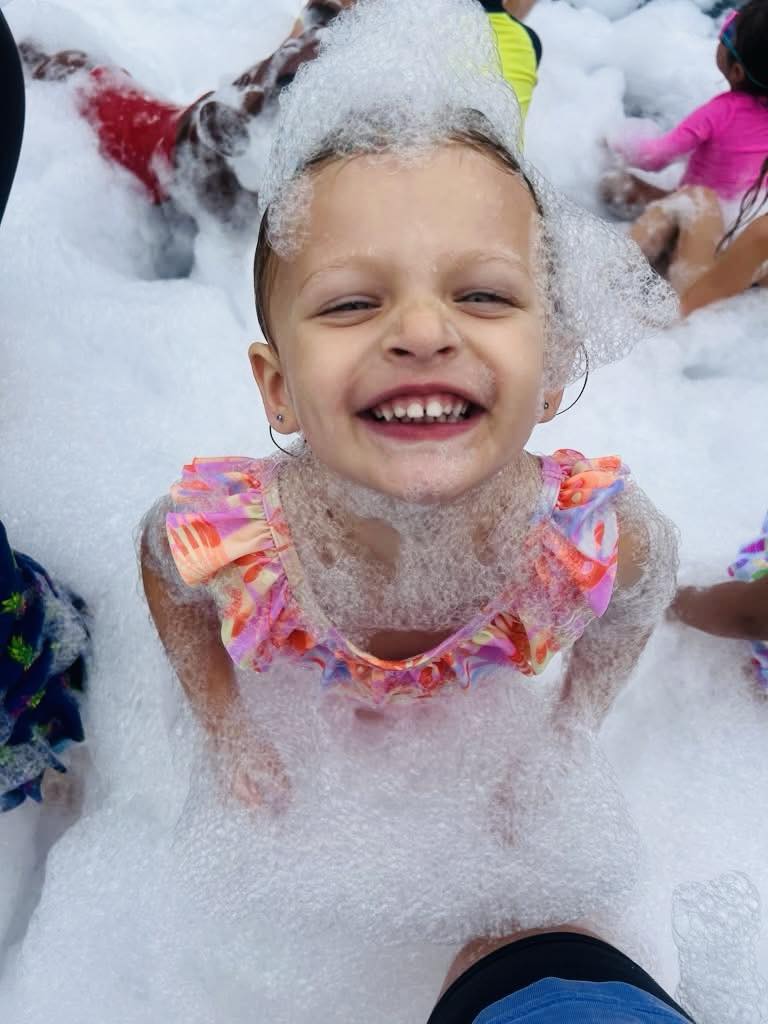 Girl laughing in foam bubbles